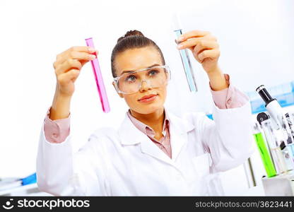 Young female scientist working with liquids in laboratory