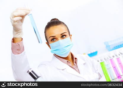 Young female scientist working with liquids in laboratory