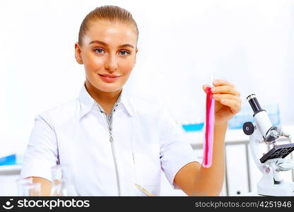 Young female scientist working with liquids in laboratory