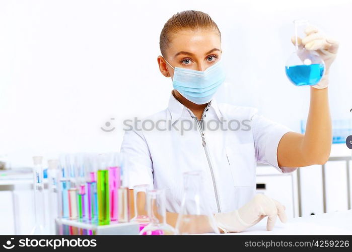 Young female scientist working with liquids in laboratory