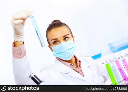 Young female scientist working with liquids in laboratory