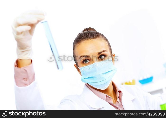Young female scientist working with liquids in laboratory