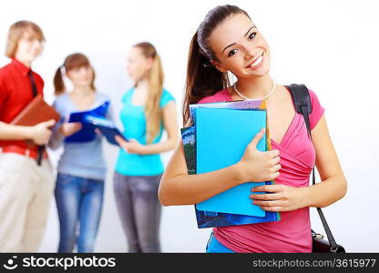 Young female student at college with books