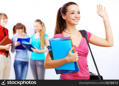 Young female student at college with books