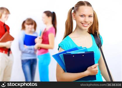 Young female student at college with books