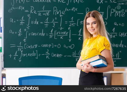 Young female student in front of the chalkboard