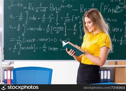 Young female student in front of the chalkboard