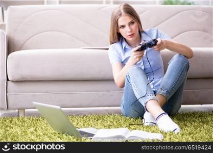 Young female student playing games at home