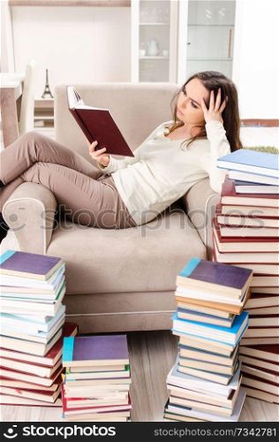 Young female student preparing for exams at home 