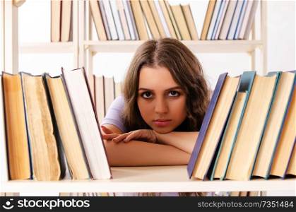 Young female student preparing for exams at library 