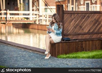 Young female student using table near bridge at Amsterdam street