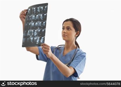 Young female surgeon analyzing ultrasound report isolated over white background