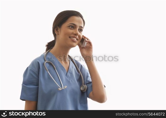 Young female surgeon on call isolated over white background