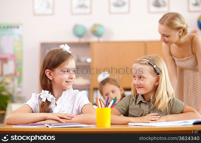 Young female teacher working with children at school