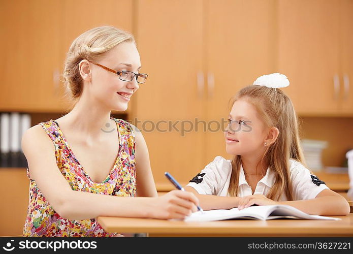 Young female teacher working with children at school