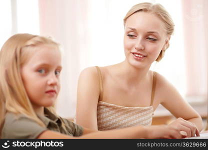 Young female teacher working with children at school