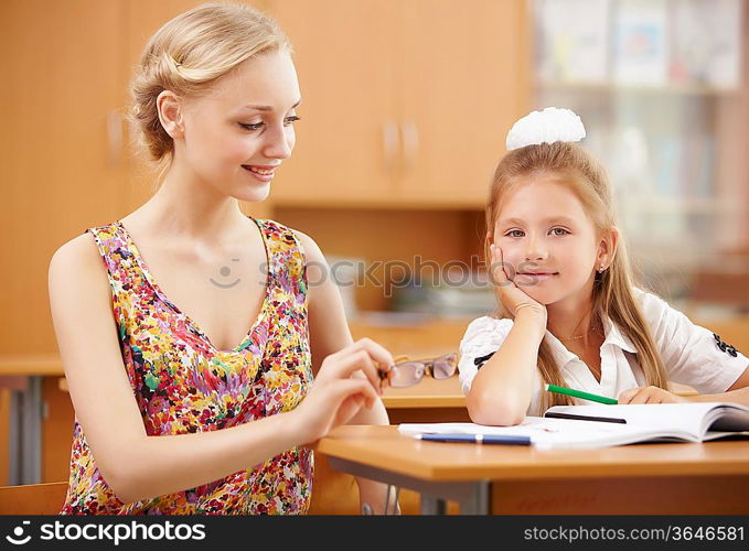 Young female teacher working with children at school