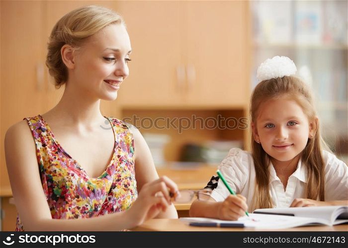 Young female teacher working with children at school