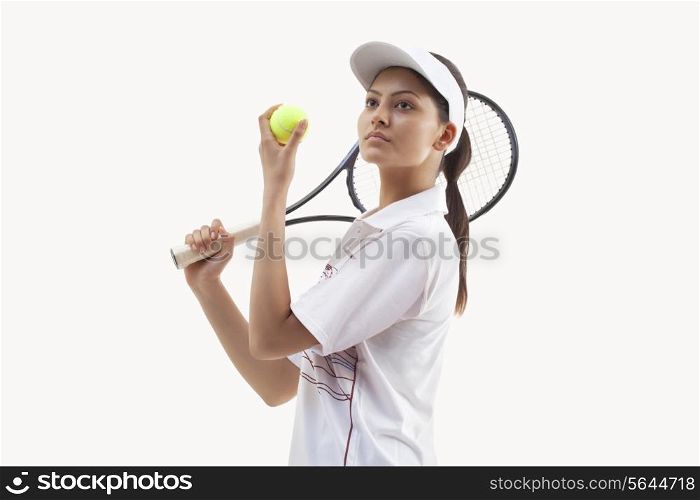 Young female tennis player ready to serve isolated over white background
