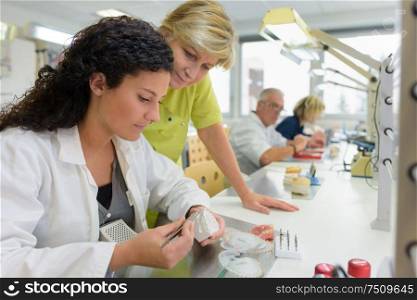 young female trainee working in a prosthetics laboratory