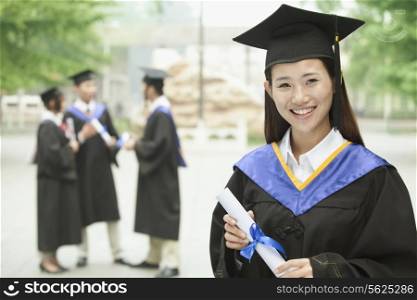 Young Female University Graduate, Portrait with Diploma