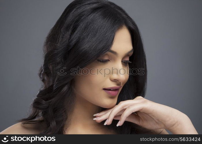 Young female with beautiful hair over colored background