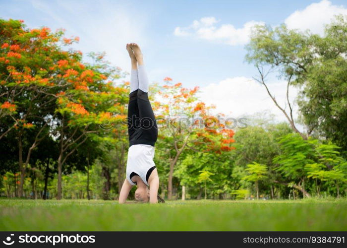 Young female with outdoor activities in the city park, Yoga is her chosen activity.