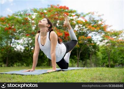 Young female with outdoor activities in the city park, Yoga is her chosen activity.