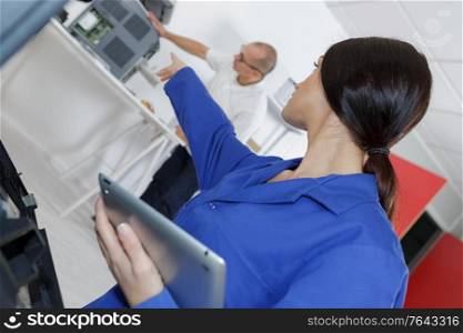 young female worker using digital tablet in manufacturing industry