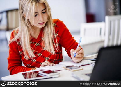 young female writing notebook