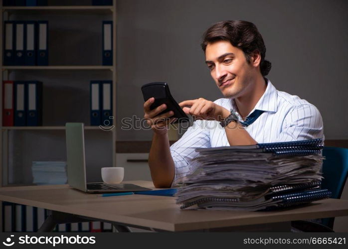 Young financial manager working late at night in office 