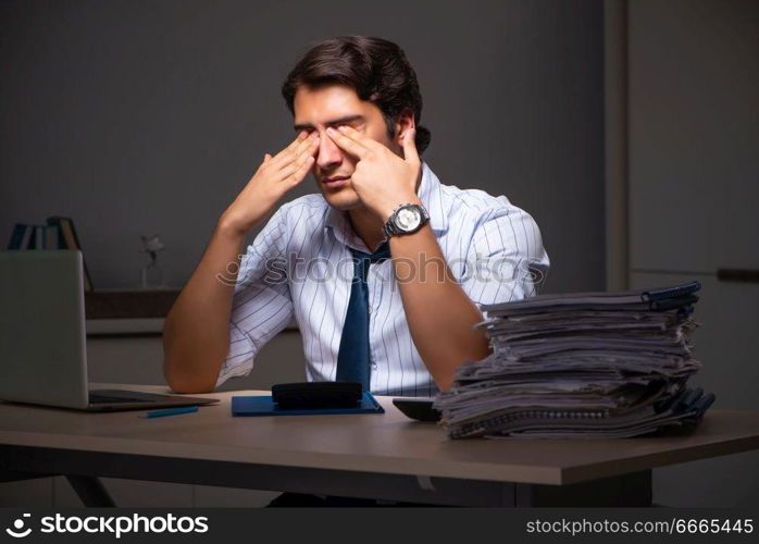 Young financial manager working late at night in office 