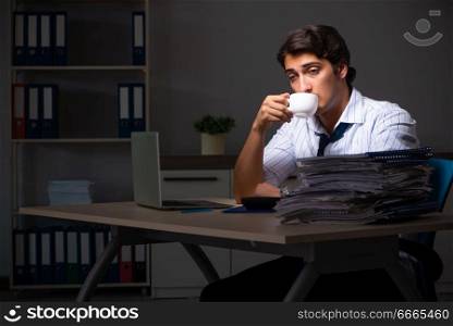 Young financial manager working late at night in office . The young financial manager working late at night in office 