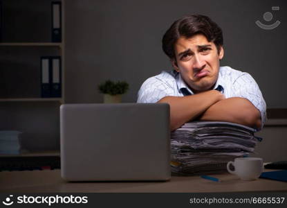 Young financial manager working late at night in office 