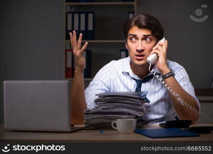 Young financial manager working late at night in office 