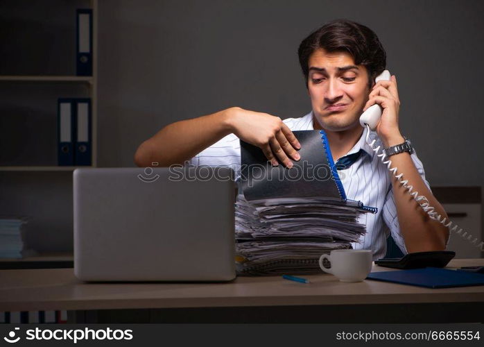 Young financial manager working late at night in office 