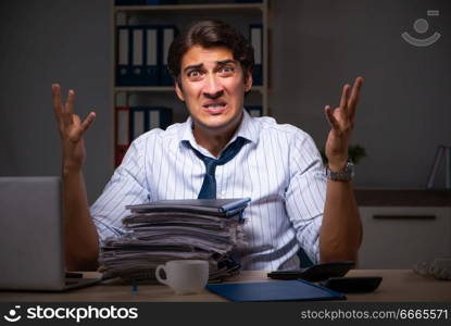 Young financial manager working late at night in office 