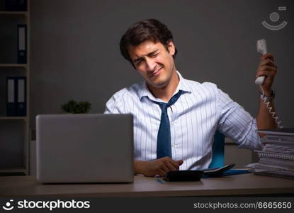 Young financial manager working late at night in office 