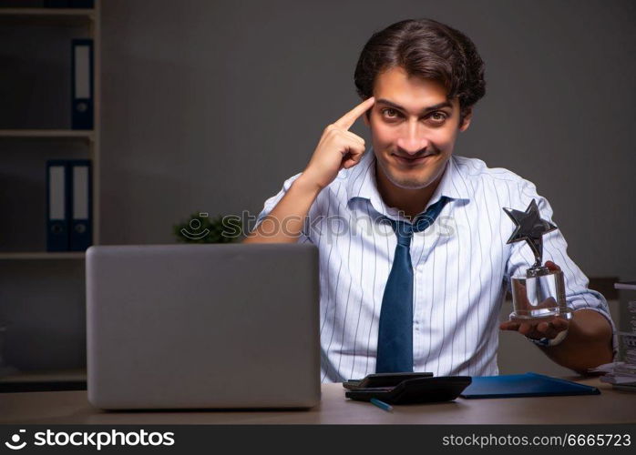 Young financial manager working late at night in office . The young financial manager working late at night in office 