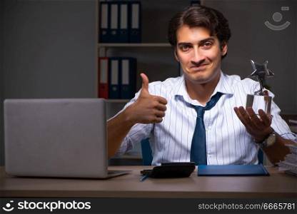 Young financial manager working late at night in office