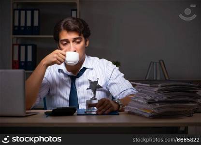 Young financial manager working late at night in office 