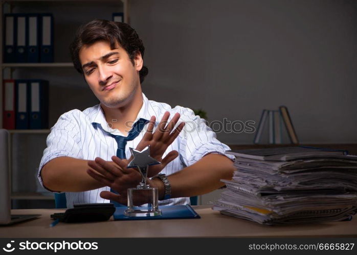 Young financial manager working late at night in office 