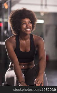 young fit african american woman doing sit ups in fitness studio at the gym.Abdominal exercises Sit up