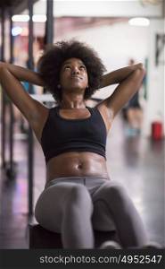young fit african american woman doing sit ups in fitness studio at the gym.Abdominal exercises Sit up