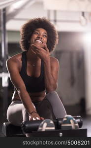 young fit african american woman doing sit ups in fitness studio at the gym.Abdominal exercises Sit up