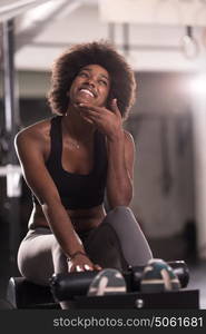 young fit african american woman doing sit ups in fitness studio at the gym.Abdominal exercises Sit up