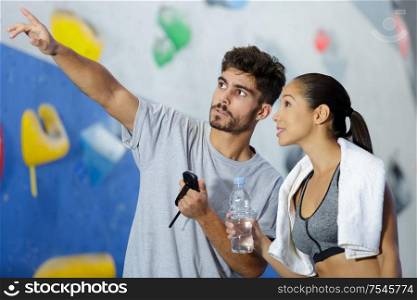 young fit man and woman in climbing session