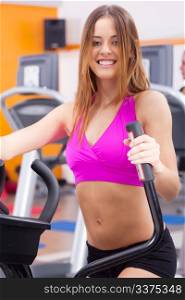 Young fit woman doing cardio exercise and posing in front of camera..