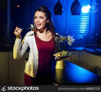 Young fit woman eating light salad