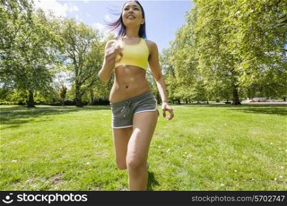 Young fit woman jogging at park